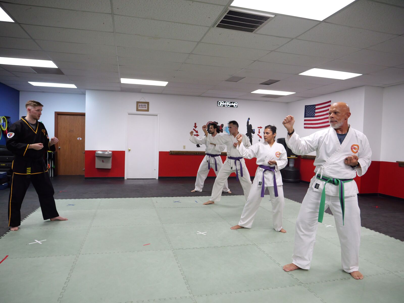 Adult class practicing self-defense drills