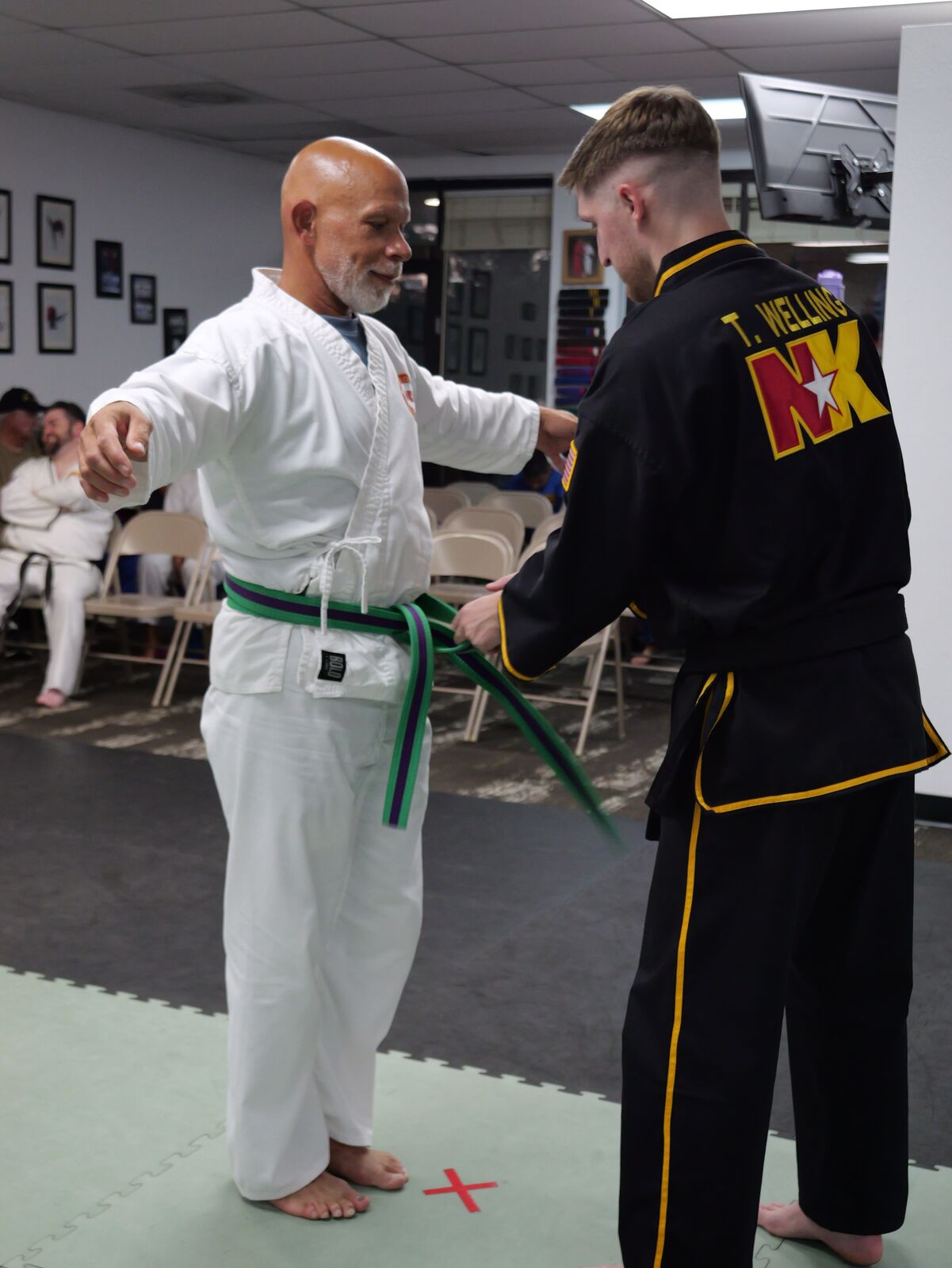 Adult class lined up training together on the mat