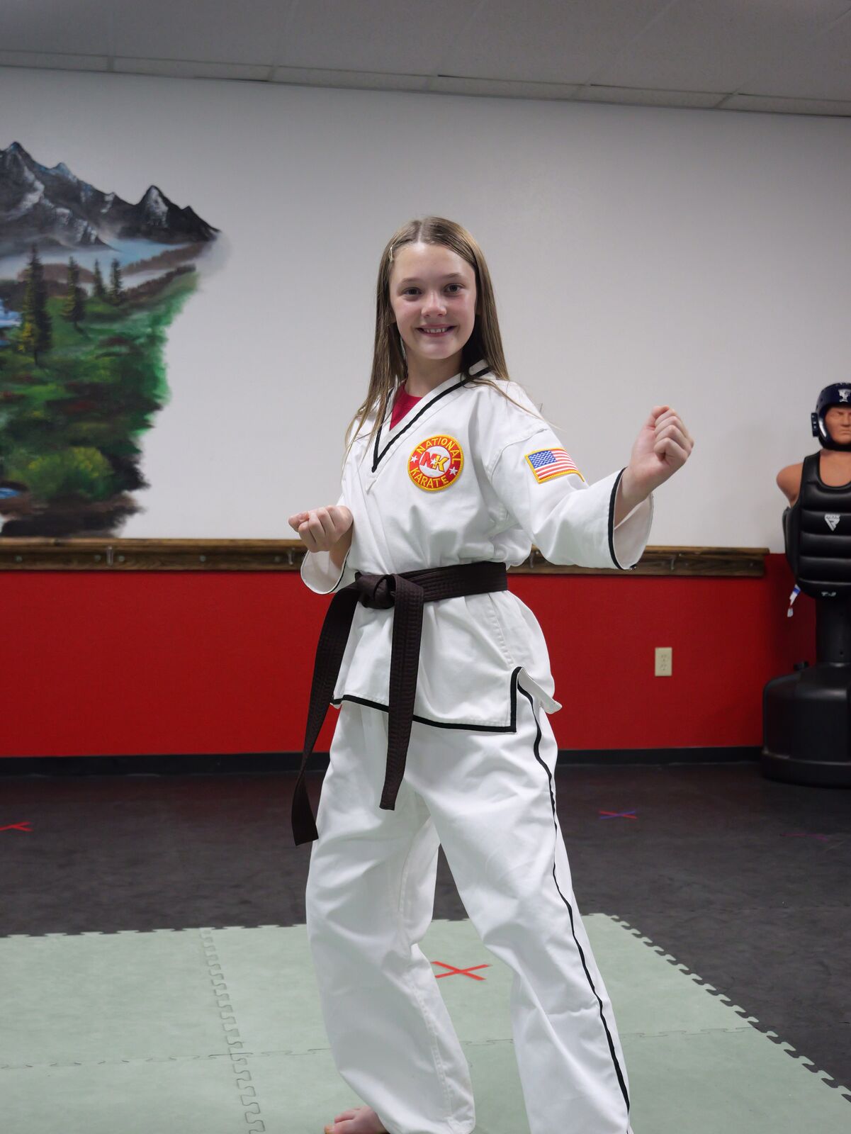 Youth students kneeling with their instructor after class
