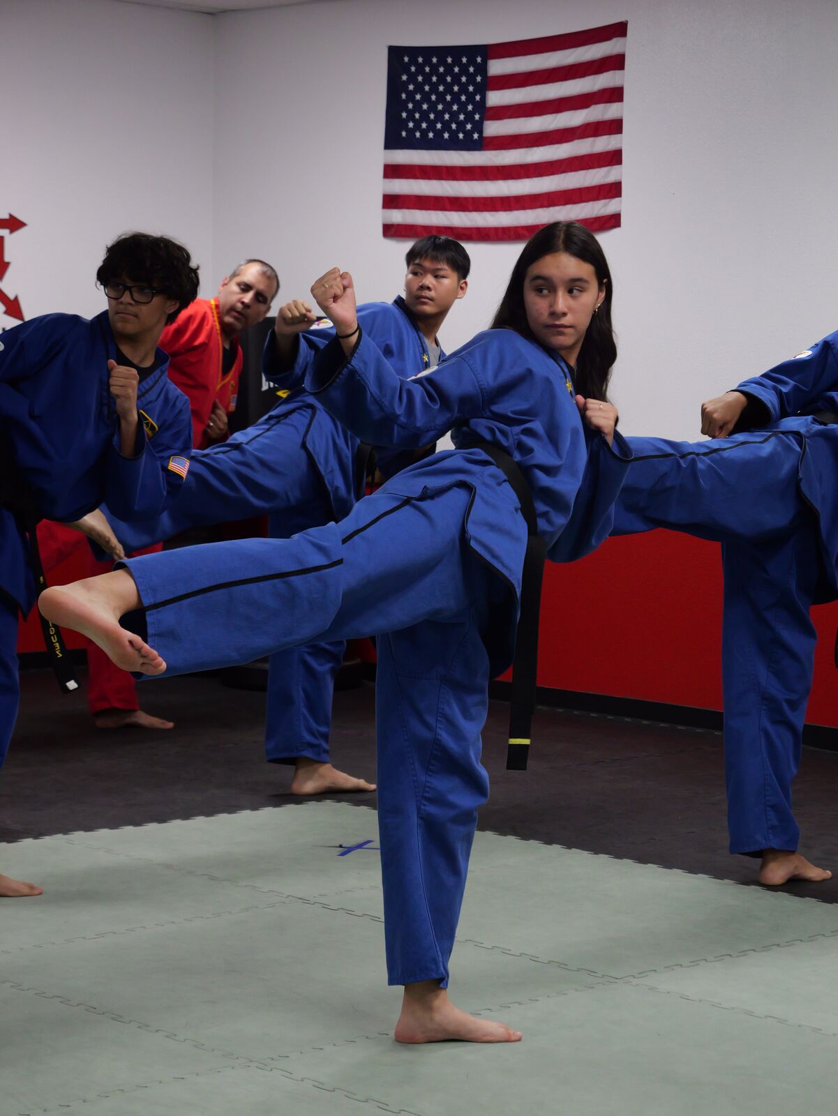 Teen student demonstrating a kick during class